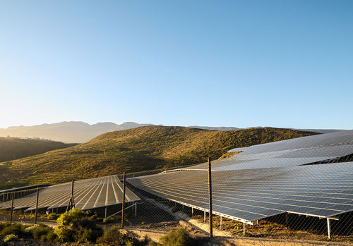 Solar panels with mountains in background