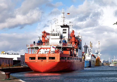 Large Industrial Boat docked next to other large boats