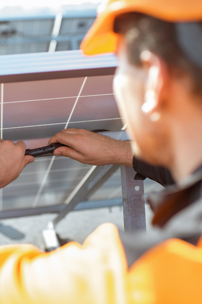 Social technician working on solar panel