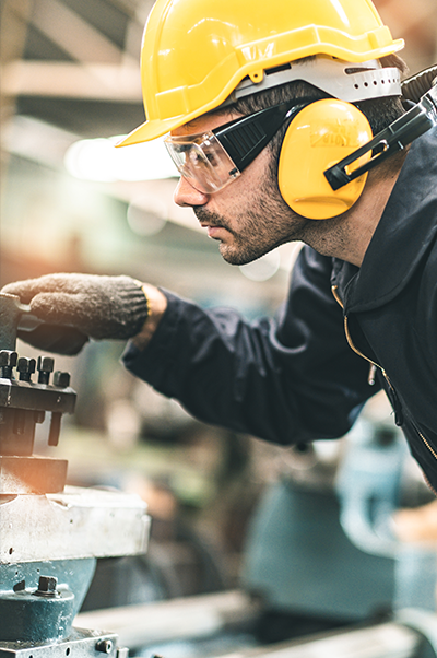 Trade worker with hard hat and safety equipment