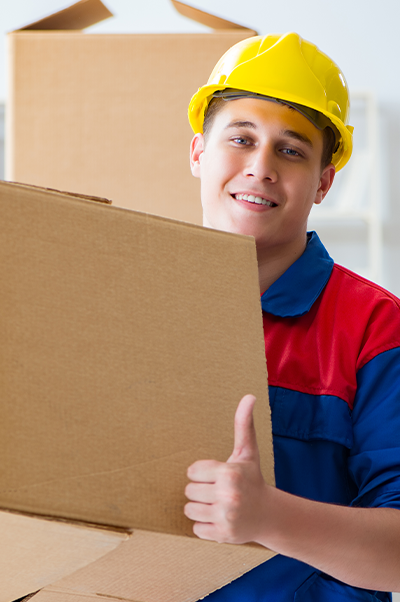 Man with hard hat moving boxes