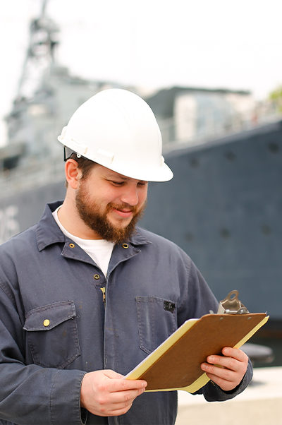 Man at a marine port with checklist