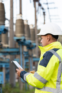 Electrician with notepad at electric plant