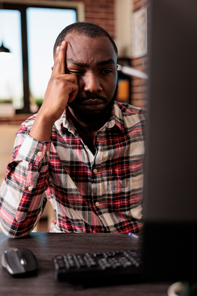 Exhausted employee on computer