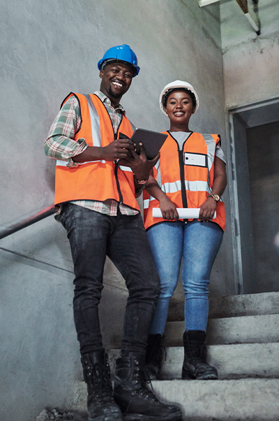 Two construction workers in hallway